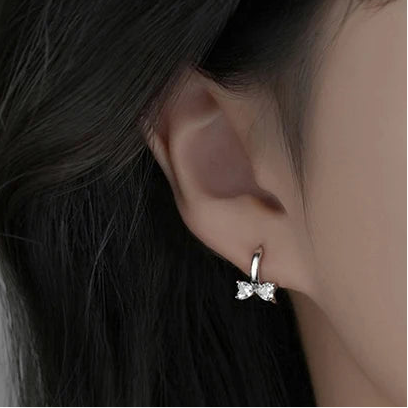 Minimalistic sterling silver earrings in the shape of a bow