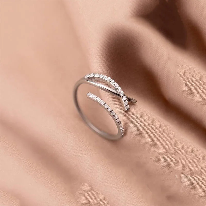 Twisted sterling silver adjustable size ring with zirconia crystals