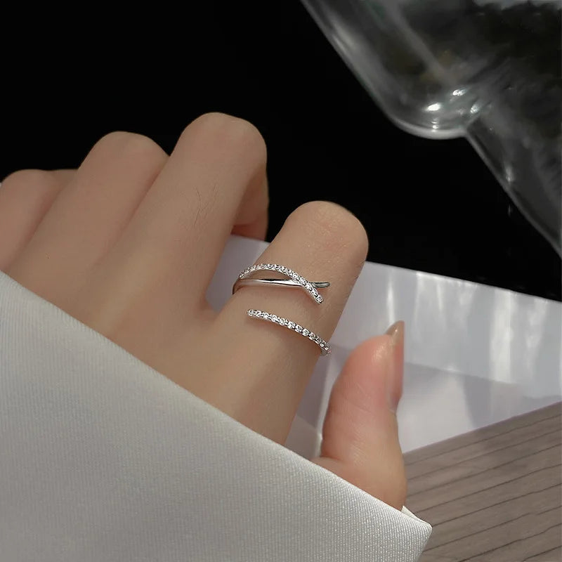 Twisted sterling silver adjustable size ring with zirconia crystals