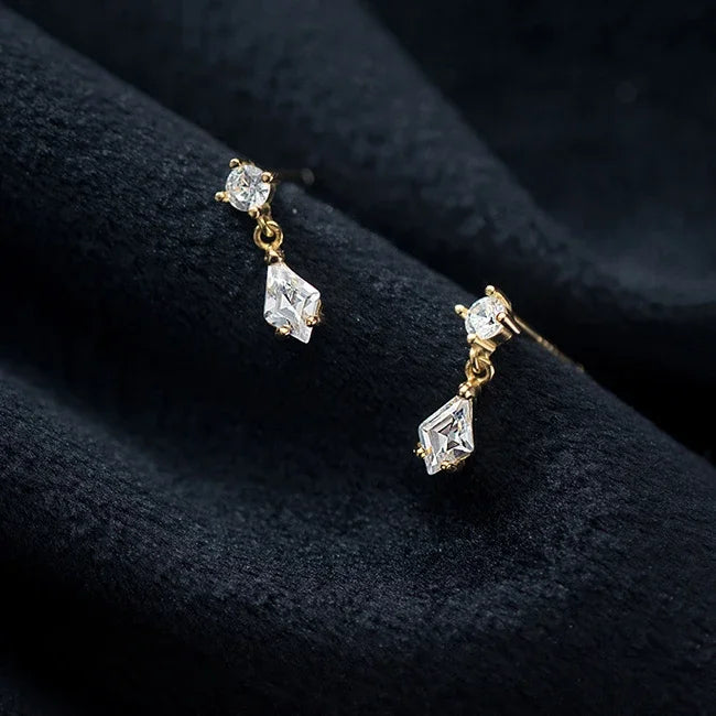 Dangling diamond-shaped sterling silver earrings with zircon crystals