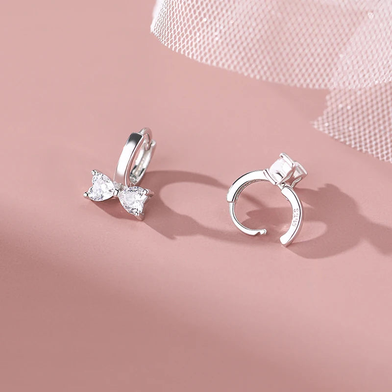 Minimalistic sterling silver earrings in the shape of a bow