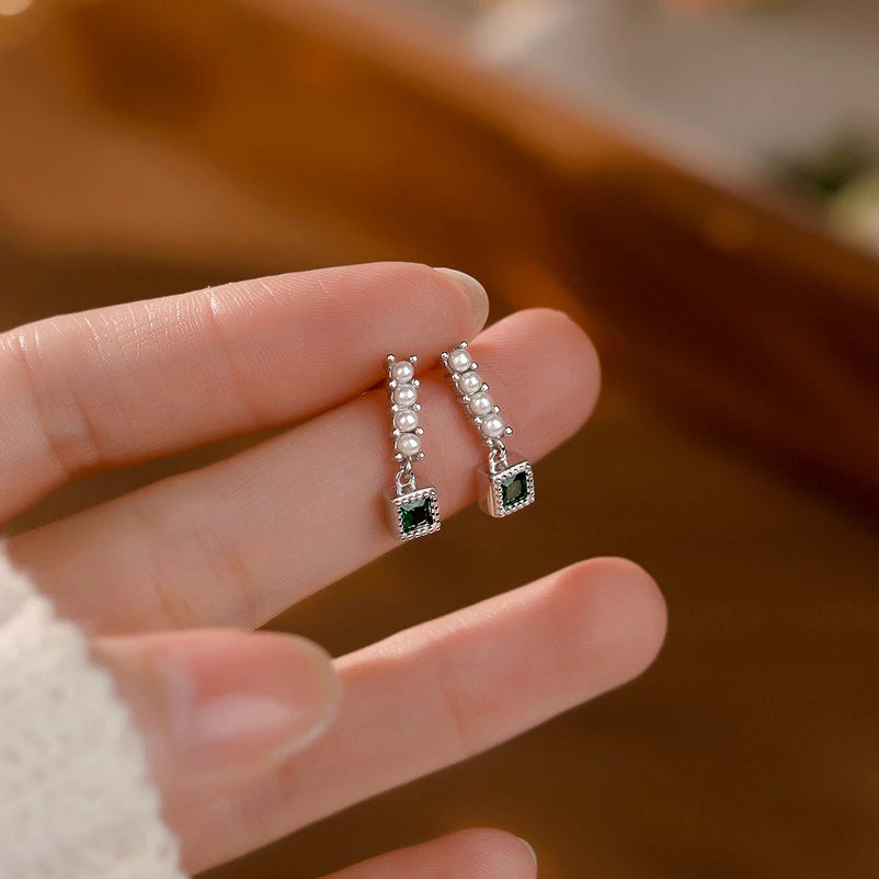 Sterling silver earrings decorated with green zirconia crystals