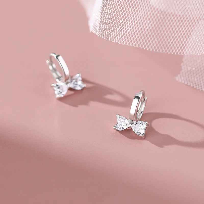 Minimalistic sterling silver earrings in the shape of a bow